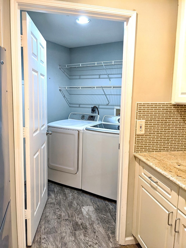 clothes washing area with washing machine and clothes dryer