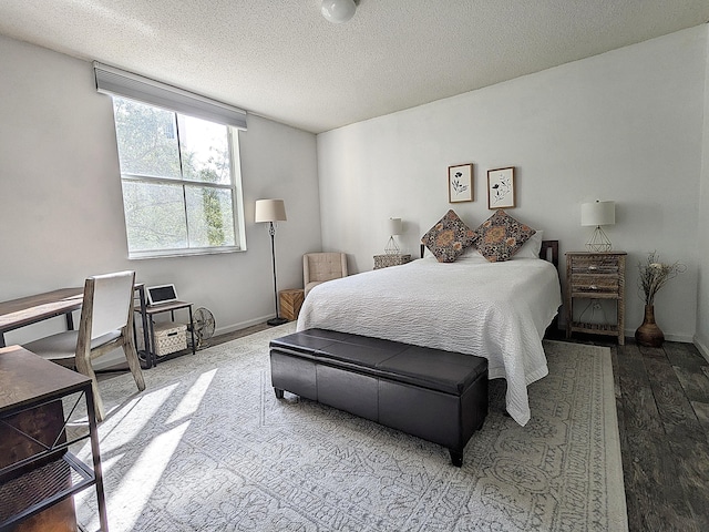 bedroom featuring hardwood / wood-style flooring and a textured ceiling