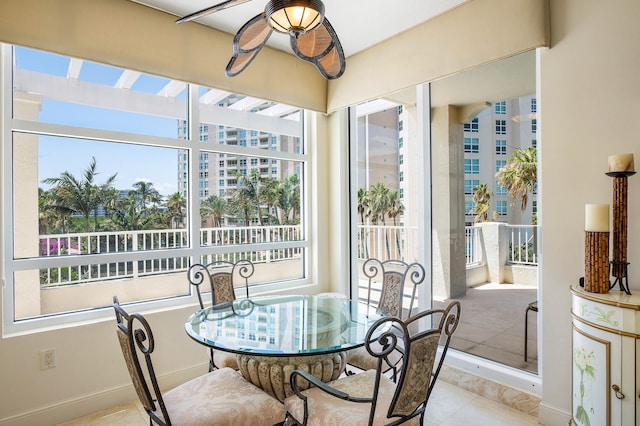 sunroom / solarium featuring ceiling fan