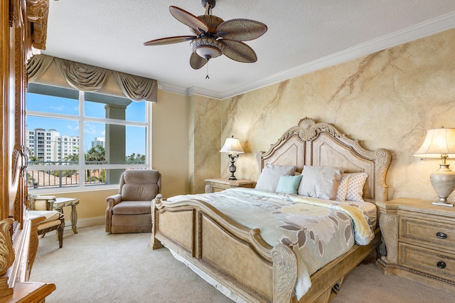 bedroom featuring a textured ceiling, ornamental molding, ceiling fan, and carpet flooring