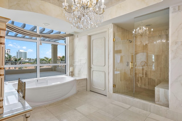 bathroom featuring independent shower and bath, a notable chandelier, and tile flooring