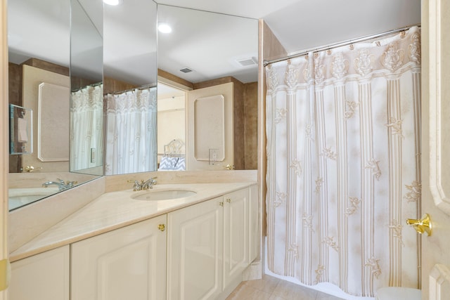 bathroom featuring tile flooring, vanity, and toilet