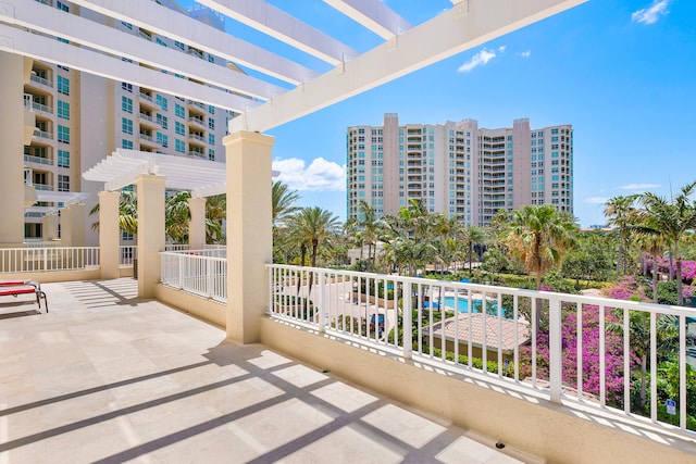 balcony with a swimming pool and a pergola