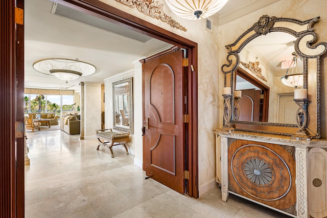 hallway featuring ornamental molding, tile floors, and ornate columns