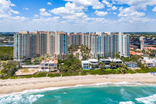 drone / aerial view featuring a water view and a beach view