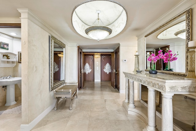 corridor with sink, light tile floors, and ornamental molding