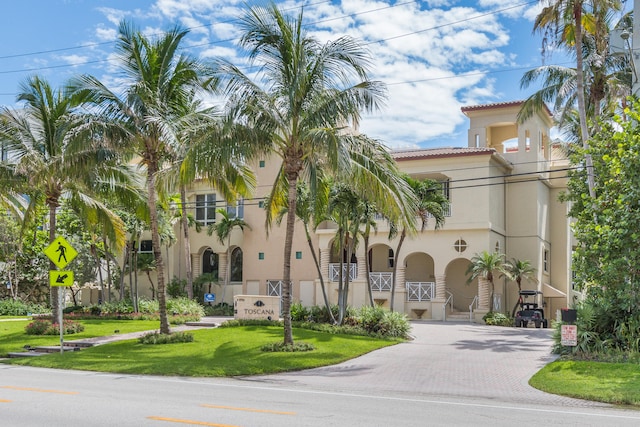 mediterranean / spanish house with a front yard