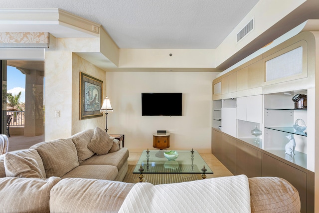 living room featuring light tile floors and a textured ceiling