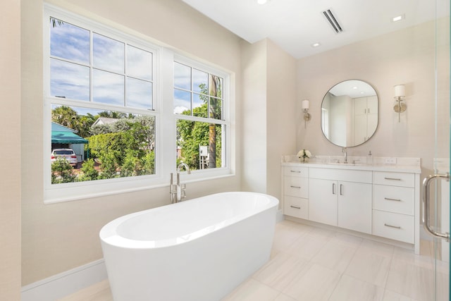 bathroom featuring a tub to relax in and vanity