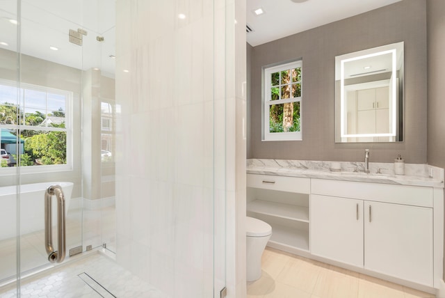 bathroom featuring tile patterned flooring, an enclosed shower, vanity, and toilet