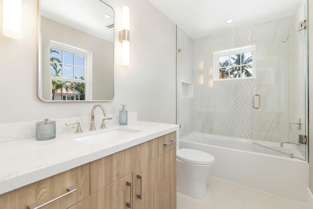 full bathroom featuring tile patterned flooring, vanity, a healthy amount of sunlight, and toilet