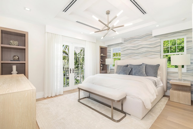 bedroom featuring light wood-type flooring, multiple windows, french doors, and access to exterior