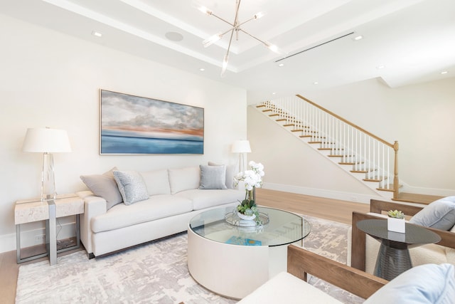 living room featuring light hardwood / wood-style flooring and a notable chandelier