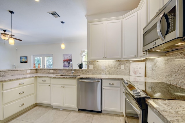 kitchen with stainless steel appliances, ceiling fan, white cabinets, and sink