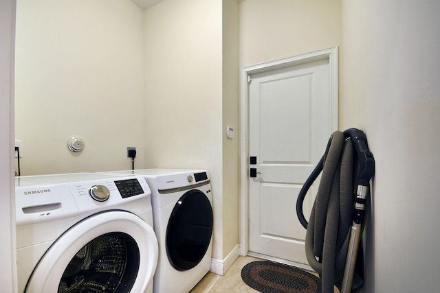 laundry area with washing machine and dryer and light tile patterned flooring