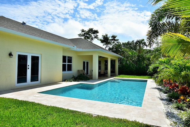 view of swimming pool featuring french doors and a patio