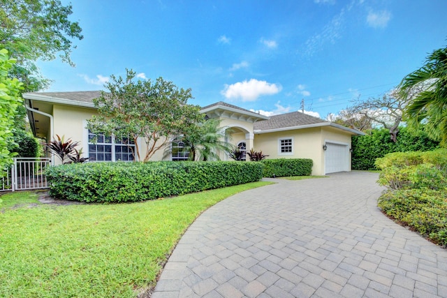 view of front of house featuring a front lawn and a garage