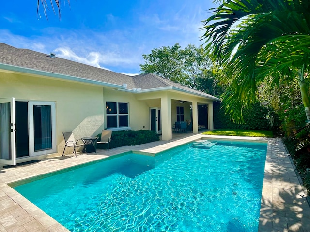 view of pool with a patio area and ceiling fan