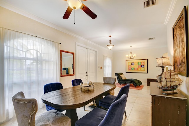 tiled dining area featuring ceiling fan with notable chandelier and crown molding