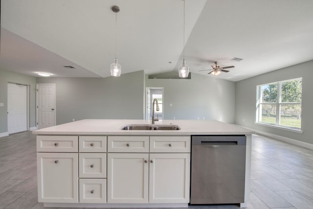 kitchen with stainless steel dishwasher, lofted ceiling, white cabinetry, and sink