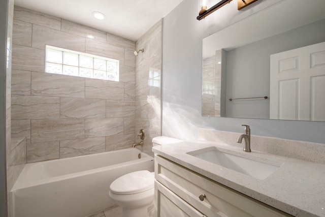 full bathroom with tiled shower / bath combo, toilet, and vanity