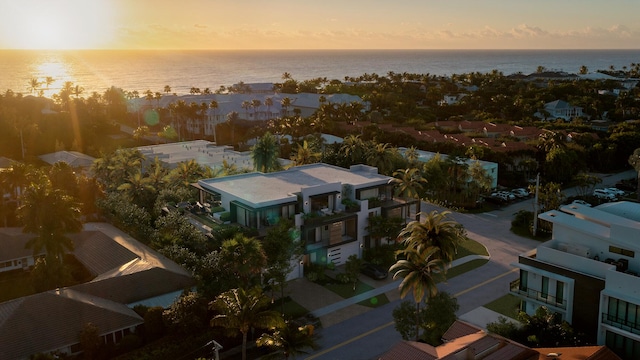 aerial view at dusk featuring a water view