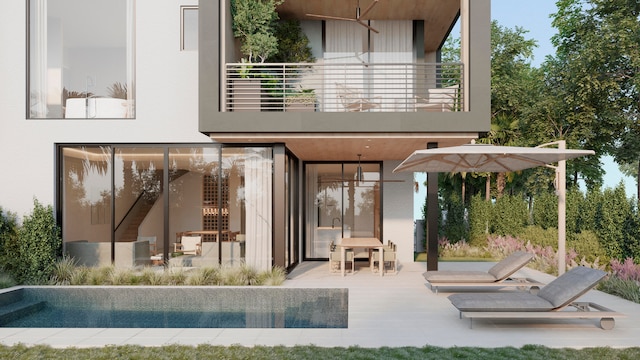 rear view of house with a balcony and a patio area