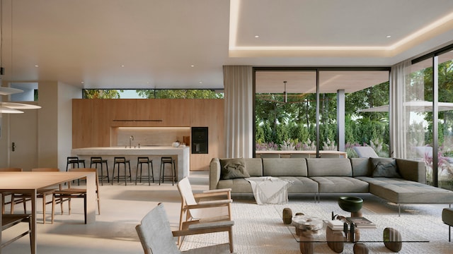 living room with floor to ceiling windows, a raised ceiling, light colored carpet, and sink