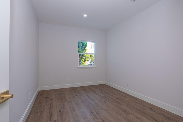 unfurnished room with dark wood-type flooring