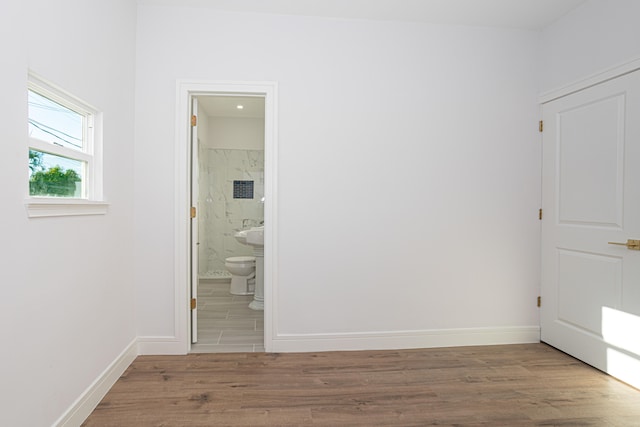 unfurnished room with dark tile floors and sink