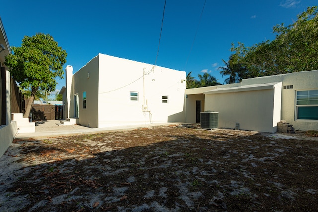 rear view of house featuring central air condition unit and a patio