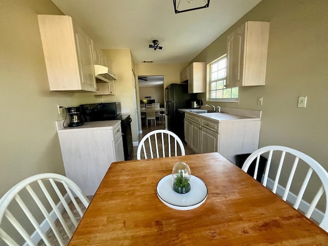 dining area with hardwood / wood-style floors and sink