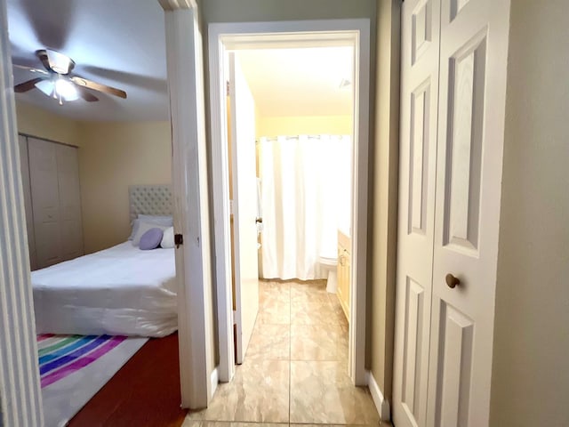 bedroom featuring ceiling fan and light tile floors