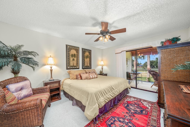 bedroom with carpet, a textured ceiling, ceiling fan, and access to exterior