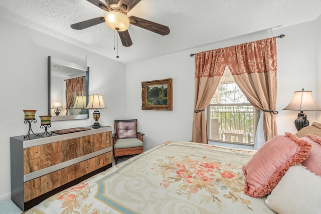 carpeted bedroom with access to outside, ceiling fan, and a textured ceiling