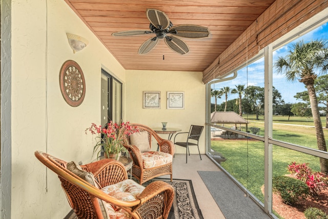 sunroom / solarium with wood ceiling and ceiling fan