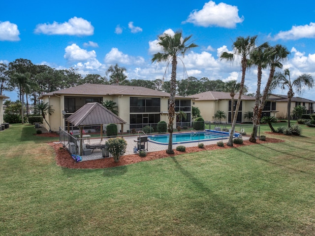 view of swimming pool with a yard