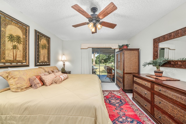 carpeted bedroom with ceiling fan, access to outside, and a textured ceiling