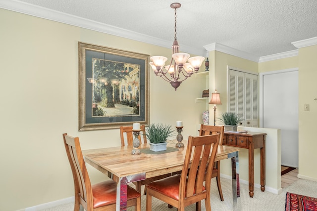 carpeted dining room with a textured ceiling, a chandelier, and ornamental molding