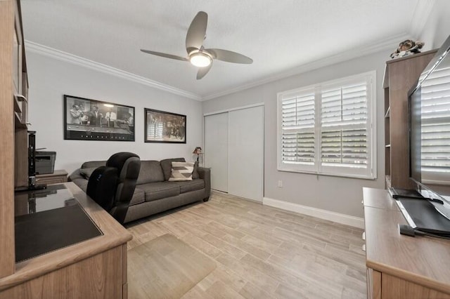 home office featuring ceiling fan, light wood-type flooring, and ornamental molding