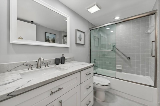 full bathroom featuring tile flooring, combined bath / shower with glass door, toilet, and large vanity