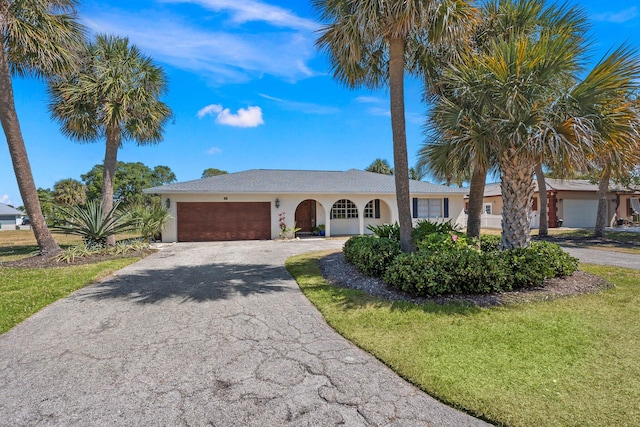 view of front facade with a front yard and a garage