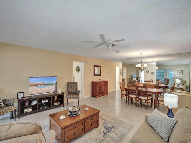 tiled living room with a textured ceiling and ceiling fan with notable chandelier