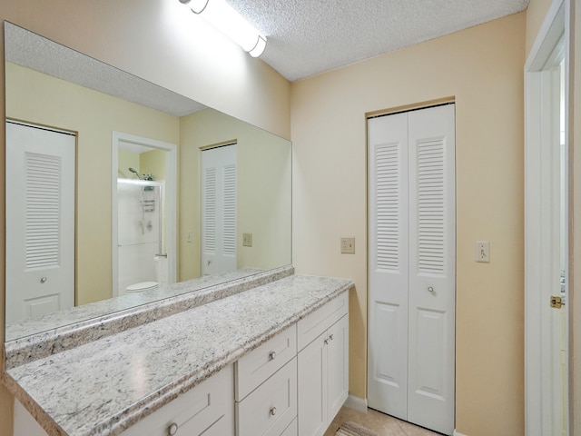 bathroom with vanity, toilet, and a shower with door