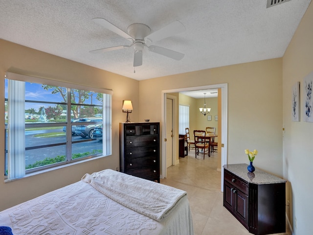 bedroom featuring a textured ceiling, a closet, and ceiling fan