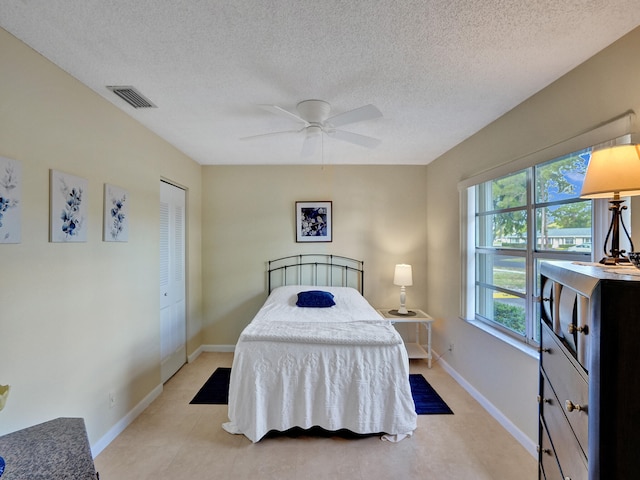 bedroom featuring a textured ceiling and ceiling fan