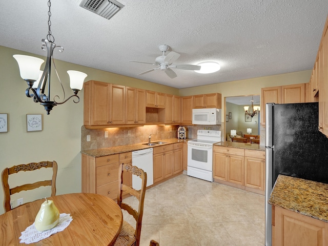 kitchen featuring white appliances, ceiling fan with notable chandelier, decorative backsplash, a textured ceiling, and decorative light fixtures