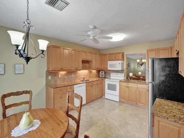 kitchen featuring light brown cabinets, white appliances, decorative light fixtures, and tasteful backsplash