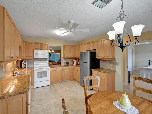 kitchen featuring pendant lighting, white appliances, light brown cabinetry, and backsplash