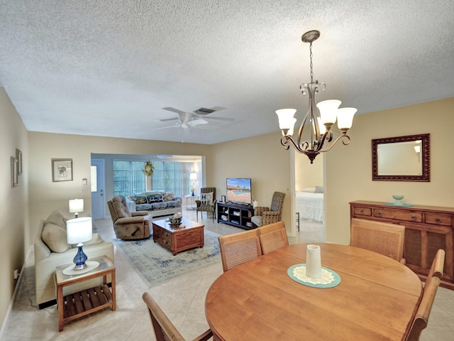 living room featuring a textured ceiling, ceiling fan with notable chandelier, and light tile patterned flooring